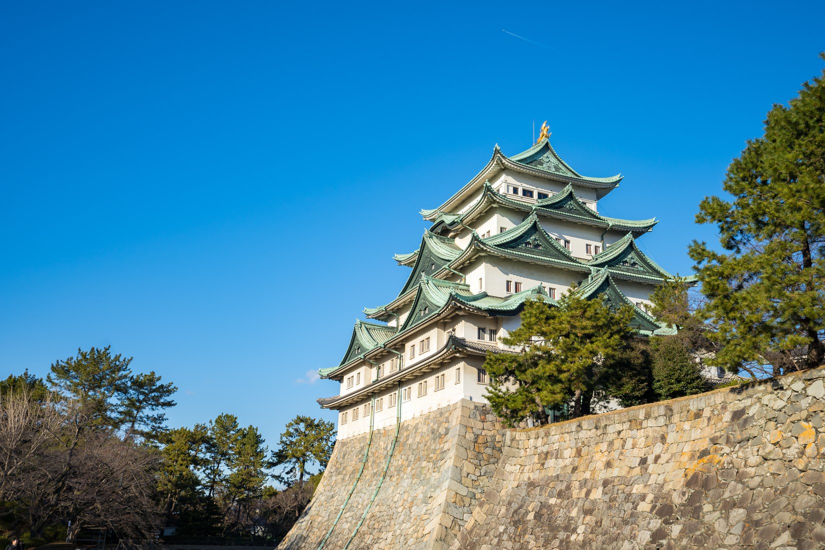 A Japanese castle beneath a clear blue sky